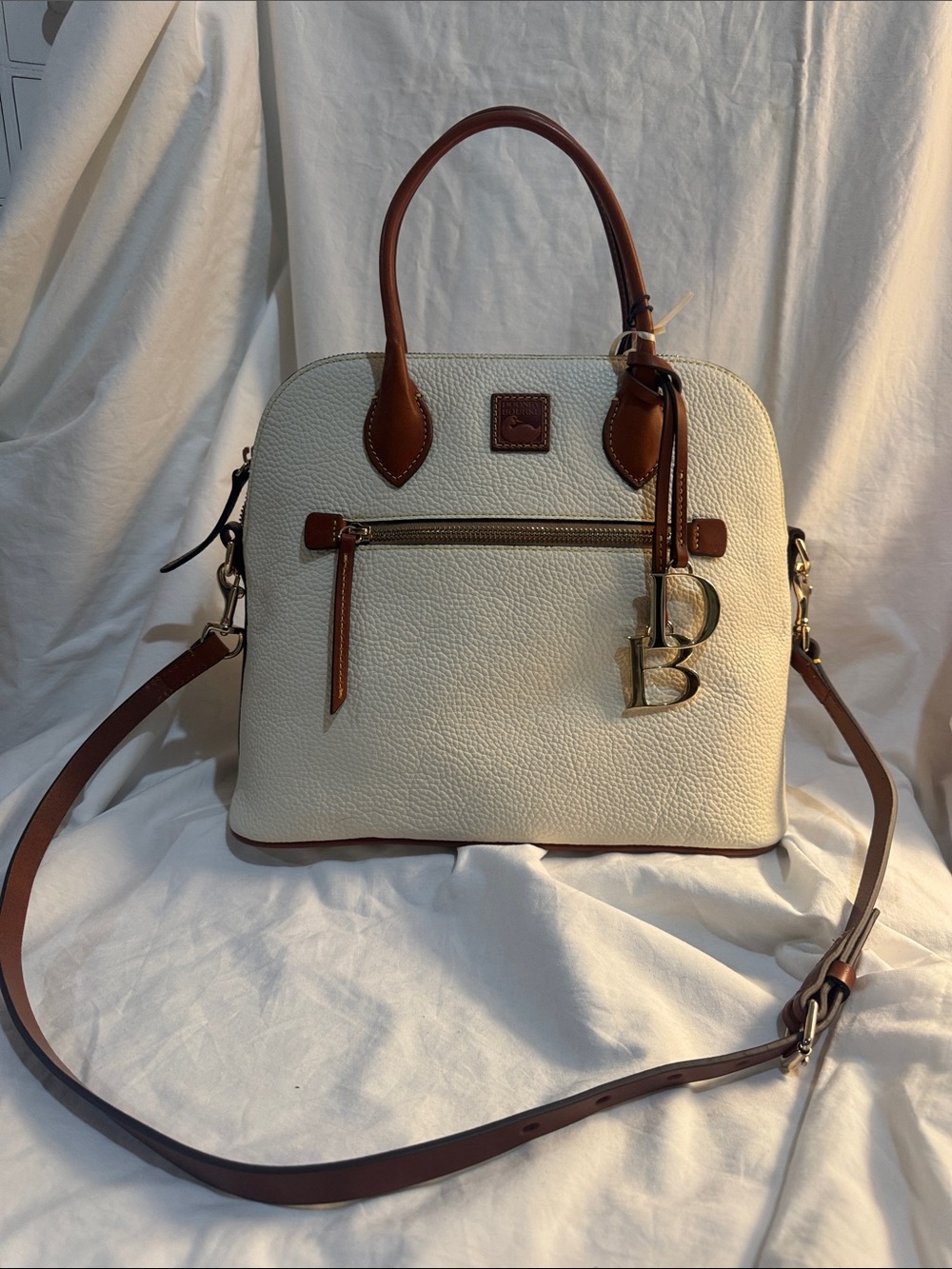 Dooney & Bourke Cream Pebbled Leather Satchel with Brown Trim and Gold Hardware